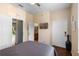 Bedroom featuring wood flooring, ceiling fan, TV, and access to bathroom at 624 Terra Lago St, Davenport, FL 33897