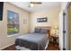Cozy bedroom with natural light, hardwood floor, ceiling fan, and comfortable bed at 624 Terra Lago St, Davenport, FL 33897