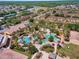 Aerial view of the community featuring a pool and recreational area, surrounded by residential buildings and lush greenery at 624 Terra Lago St, Davenport, FL 33897