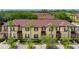 Inviting townhome exterior featuring a well-maintained lawn and lush landscaping at 624 Terra Lago St, Davenport, FL 33897