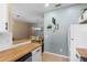 Open kitchen view of dining area with chandelier, light-blue wall, and white appliances at 624 Terra Lago St, Davenport, FL 33897