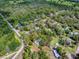 Aerial view of a residential property enclosed in a red border surrounded by mature trees at 6731 Lake Griffin Rd, Lady Lake, FL 32159