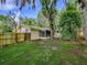 This backyard features a fenced-in yard with lush trees and a patio at 6731 Lake Griffin Rd, Lady Lake, FL 32159