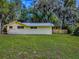A well-manicured backyard with lush green grass and a sturdy wooden fence, enhancing privacy and charm at 6731 Lake Griffin Rd, Lady Lake, FL 32159