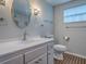 This bathroom features a stylish vanity with a round mirror and modern fixtures at 6731 Lake Griffin Rd, Lady Lake, FL 32159