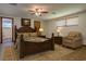 Comfortable bedroom featuring a wooden bed frame, a ceiling fan, and neutral-toned walls at 6731 Lake Griffin Rd, Lady Lake, FL 32159