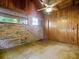 This room features a brick wall, wood paneling, and a ceiling fan with lighting at 6731 Lake Griffin Rd, Lady Lake, FL 32159