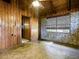 This room features wood paneling, a brick wall, and a window with a view at 6731 Lake Griffin Rd, Lady Lake, FL 32159