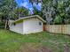 Exterior view of backyard area featuring a wooden fence, house, and shed at 6731 Lake Griffin Rd, Lady Lake, FL 32159