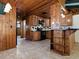 Warm wood kitchen with ample cabinetry, black appliances, and a peninsula with seating, perfect for casual dining at 6731 Lake Griffin Rd, Lady Lake, FL 32159