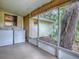 This screened porch features a washer, dryer, and a view of the backyard at 6731 Lake Griffin Rd, Lady Lake, FL 32159