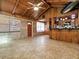 Tile floored Living room with brick accents, wood-paneled ceilings, and an open layout, great for modern living at 6731 Lake Griffin Rd, Lady Lake, FL 32159