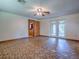 Open-concept living room with French doors and adjacent kitchen at 6731 Lake Griffin Rd, Lady Lake, FL 32159