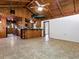 Spacious living area featuring wood ceilings, tile floors, and an open layout to the kitchen, ideal for entertaining at 6731 Lake Griffin Rd, Lady Lake, FL 32159