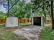 This backyard features two large sheds with concrete paths for easy access at 6731 Lake Griffin Rd, Lady Lake, FL 32159