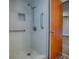 This bathroom features a sleek, tiled shower with a modern showerhead and grab bars at 6731 Lake Griffin Rd, Lady Lake, FL 32159