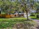 Lush front yard features mature trees providing plenty of shade and privacy at 6731 Lake Griffin Rd, Lady Lake, FL 32159