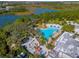 Aerial view of community pool, kiddie splash park, and surrounding landscaping, creating a resort-like atmosphere at 709 Longboat Dr, Davenport, FL 33896