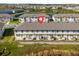 An aerial view of new home construction in a Primary-planned community with a lake in the background at 709 Longboat Dr, Davenport, FL 33896