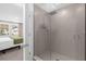 Modern bathroom featuring a glass-enclosed shower with tile walls and a view into the bedroom at 709 Longboat Dr, Davenport, FL 33896