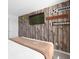 Stylish bedroom featuring a wood paneled wall with TV and sports themed decor at 709 Longboat Dr, Davenport, FL 33896