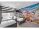 ' bedroom with bunk beds and a vivid Disney-themed mural, creating a playful atmosphere at 709 Longboat Dr, Davenport, FL 33896