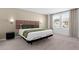 Comfortable bedroom featuring a plush bed with a padded headboard and natural light from the window at 709 Longboat Dr, Davenport, FL 33896