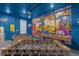 Vibrant game room with foosball, pool table, and colorful graffiti art, perfect for entertainment at 709 Longboat Dr, Davenport, FL 33896
