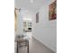Hallway with modern paneling, decorative artwork, and a view into the living space at 709 Longboat Dr, Davenport, FL 33896