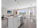 Bright kitchen with a center island, stainless steel appliances, and open to the living area at 709 Longboat Dr, Davenport, FL 33896