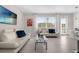 Bright living room featuring modern sofas, tile floors, and large windows at 709 Longboat Dr, Davenport, FL 33896