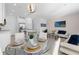 Open-concept living space with modern furnishings, kitchen island, and dining area at 709 Longboat Dr, Davenport, FL 33896