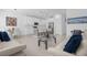Open-concept living space with modern white furnishings and tile floors at 709 Longboat Dr, Davenport, FL 33896