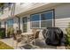 Cozy outdoor patio area with table, four chairs and grill, ideal for dining alfresco at 709 Longboat Dr, Davenport, FL 33896