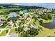 Aerial view of the home showing its location among other residences, near a lake, with a property line marked in red at 7303 Spring Mountain Ln, Yalaha, FL 34797