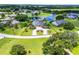 Scenic aerial view of a luxury home, marked with a red property line, located near a pond and lush greenery at 7303 Spring Mountain Ln, Yalaha, FL 34797