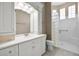 Bright bathroom with white cabinetry, tile flooring, and a glass-block shower at 7303 Spring Mountain Ln, Yalaha, FL 34797