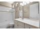 Full bathroom featuring a single sink vanity, toilet, and shower-tub combination with a large mirror at 7303 Spring Mountain Ln, Yalaha, FL 34797