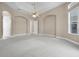 Spacious bedroom with neutral carpet and views of the backyard at 7303 Spring Mountain Ln, Yalaha, FL 34797