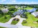 Beautiful home featuring manicured lawns, mature palm trees, and a circular driveway leading to the grand entrance at 7303 Spring Mountain Ln, Yalaha, FL 34797
