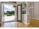 Elegant foyer showcasing a decorative front door, chandelier, hardwood floors, and sophisticated architectural details at 7303 Spring Mountain Ln, Yalaha, FL 34797