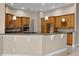 Spacious kitchen features wood cabinetry and a large island with countertop seating at 7303 Spring Mountain Ln, Yalaha, FL 34797