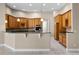 Spacious kitchen with custom cabinets, modern appliances, and a breakfast bar at 7303 Spring Mountain Ln, Yalaha, FL 34797