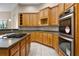 Kitchen featuring wooden cabinetry, stainless steel oven, and modern countertops at 7303 Spring Mountain Ln, Yalaha, FL 34797