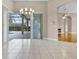 Bright living room with tile flooring, fireplace, and views of the screened-in pool area at 7303 Spring Mountain Ln, Yalaha, FL 34797