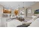 Open concept living room featuring a large seating area with views to the kitchen and breakfast bar at 7303 Spring Mountain Ln, Yalaha, FL 34797