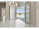 Living room with tiled floors and sliding doors to a screened-in pool and lake view at 7303 Spring Mountain Ln, Yalaha, FL 34797