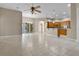 Open living space with tile floors, fan and views of kitchen and breakfast nook at 7303 Spring Mountain Ln, Yalaha, FL 34797
