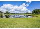 Picturesque pond view from the property, enhancing the serene and natural setting of the home at 7303 Spring Mountain Ln, Yalaha, FL 34797