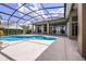 Private screened-in pool offers a relaxing outdoor space with ample deck area for lounging and entertaining at 7303 Spring Mountain Ln, Yalaha, FL 34797